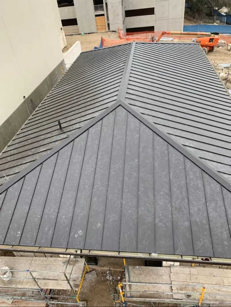 Commercial metal roof construction with crane equipment in Sunnyvale